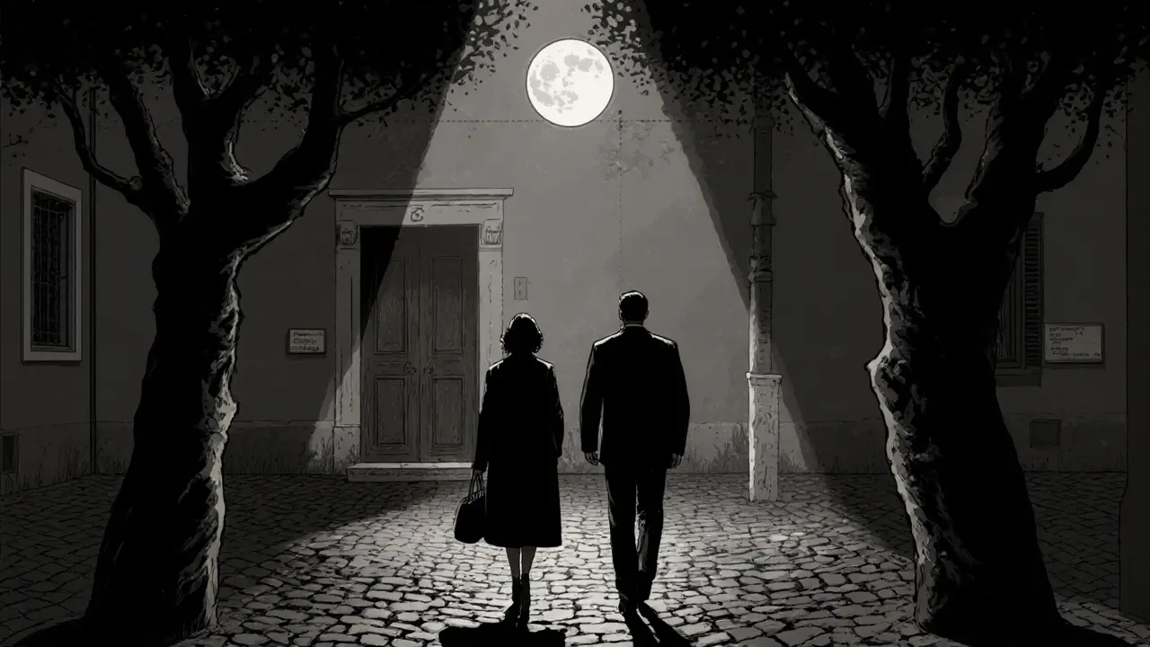 A couple walking in silhouette through a moonlit Milan courtyard leading to a private entrance.