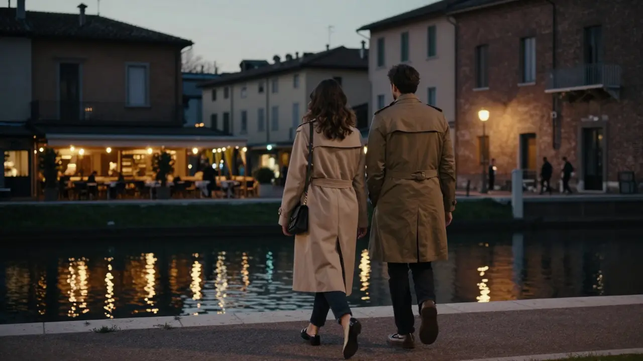 A couple walks peacefully along a canal at dusk, surrounded by historic Milanese architecture and warm lamplight.